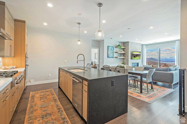 Kitchen featuring a sink, a center island with sink, recessed lighting, modern cabinets, and appliances with stainless steel finishes | Image 9