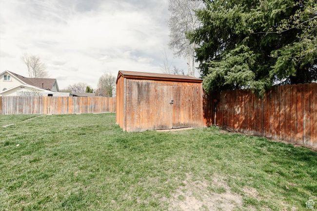 View of yard with a storage shed, an outbuilding, and a fenced backyard | Image 35
