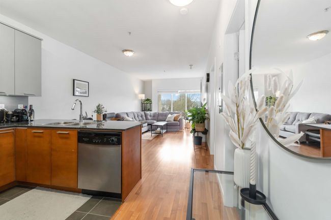 Kitchen featuring open floor plan, brown cabinets, dishwasher, and a peninsula | Image 15