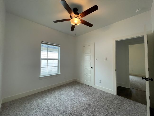 Unfurnished bedroom featuring carpet floors, baseboards, and ceiling fan | Image 28
