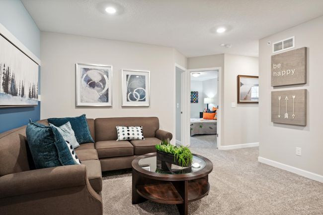 The upper level loft provides additional sq. ft. of living space and is conveniently located adjacent to all three of the bedrooms. *Please note, photos are of a model and are not the actual home. | Image 13