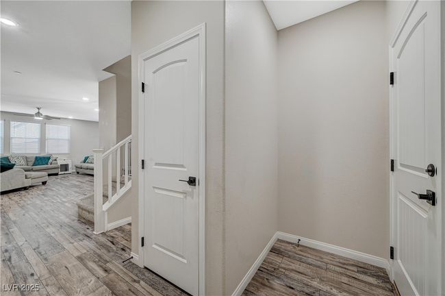Hall featuring wood finished floors, recessed lighting, baseboards, and stairway | Image 6