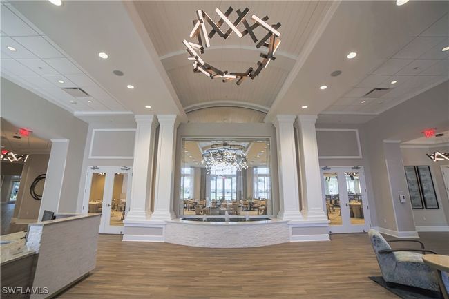 Entrance foyer with french doors, an inviting chandelier, and ornate columns | Image 47