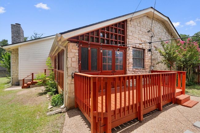 Rear view of property with stone siding, a wooden deck, and a chimney | Image 31