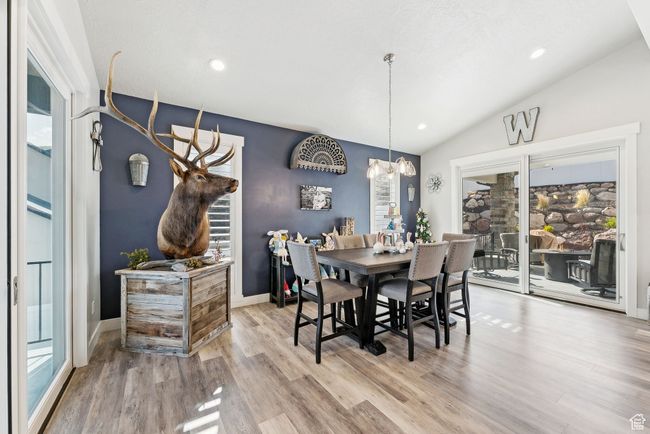 Dining room featuring wood finished floors, lofted ceiling, and plenty of natural light | Image 41