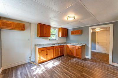 Kitchen featuring a drop ceiling, sink, and dark hardwood / wood-style flooring | Image 3