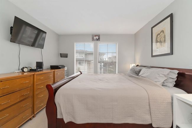 Bedroom featuring light colored carpet | Image 19
