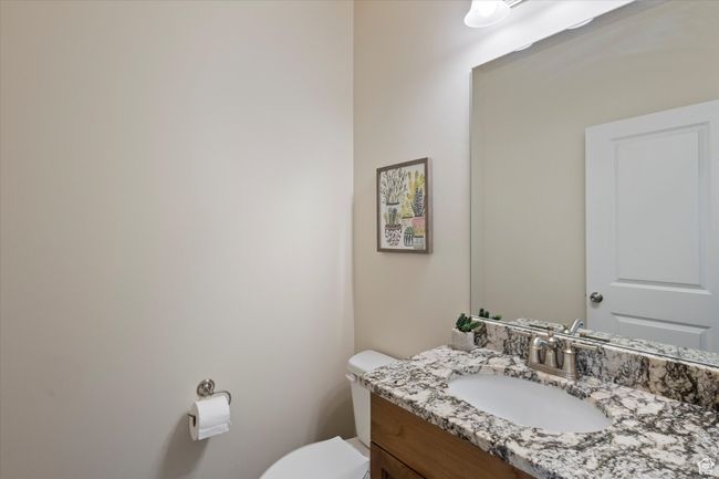 1st floor half bath featuring toilet and vanity | Image 12