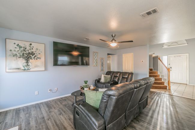 Living room featuring stairs, a ceiling fan, and wood finished floors | Image 14