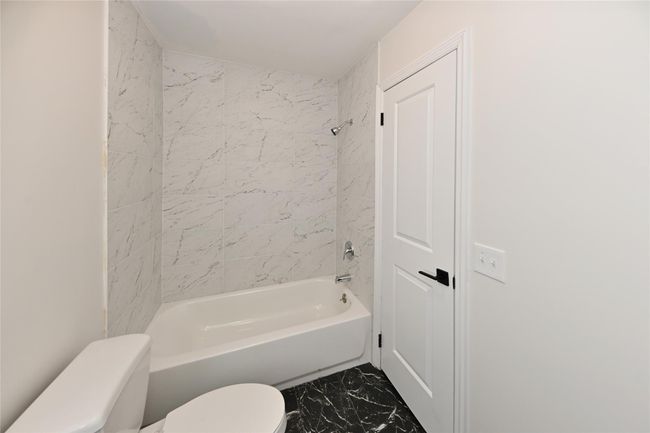 Full bath with toilet, marble finish floor, and shower combination | Image 18
