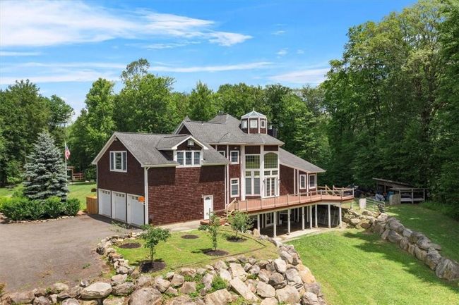 Your gorgeous, sun filled home with 3 car garage that boast 9' ceilings. A path leading to your lower level with sliding glass doors. | Image 4