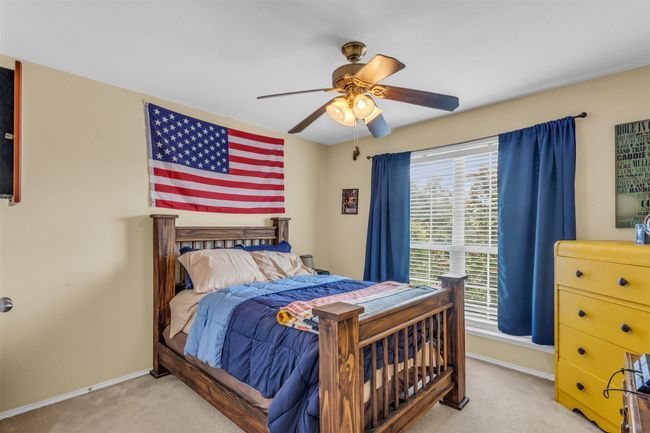 Carpeted bedroom featuring ceiling fan | Image 29