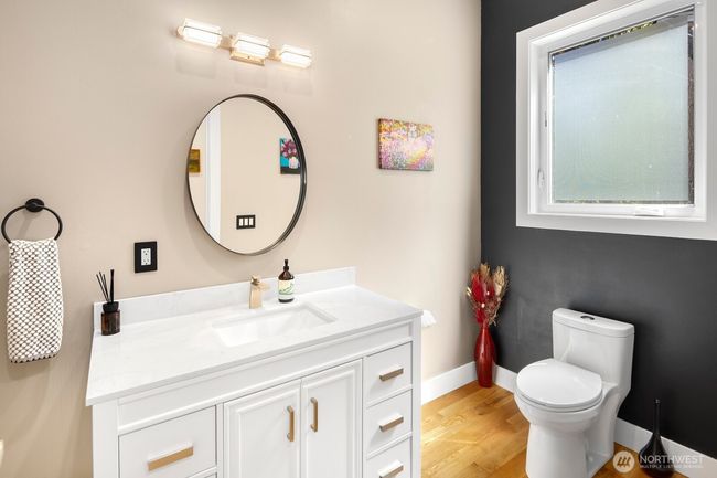 Main floor powder room, adjacent to but removed from entertaining spaces. | Image 27