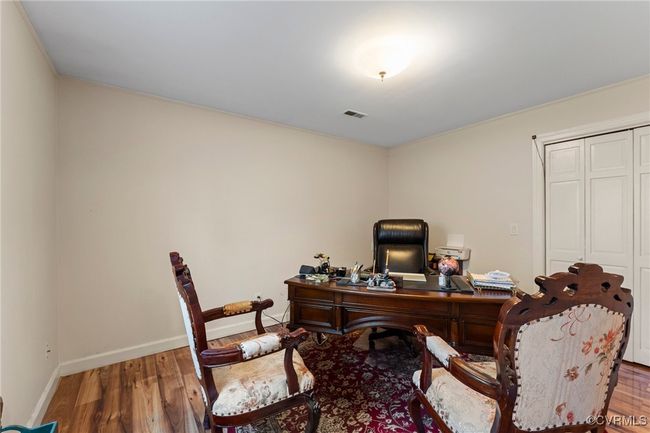 Office featuring visible vents, wood finished floors, and baseboards | Image 37