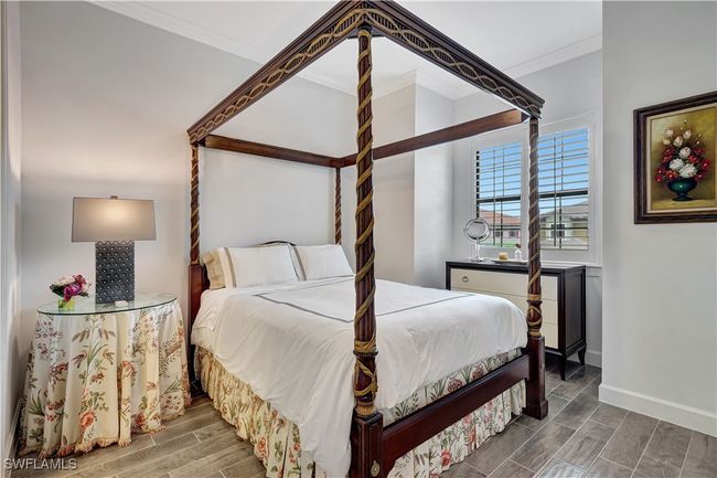 Second bedroom with crown molding and wide plank tile flooring | Image 20