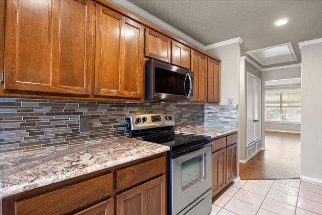 Light bright kitchen with dinning area and open access to very large back courtyard through sliding Pella doors with shade inserts. | Image 13