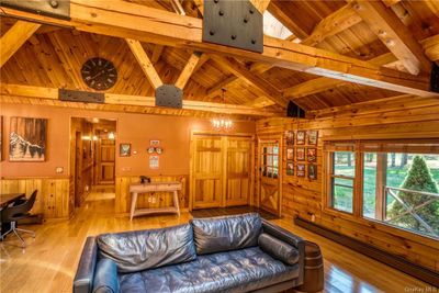 Living room featuring light hardwood / wood-style floors, baseboard heating, vaulted ceiling with beams, and wooden ceiling | Image 3