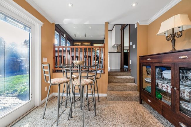 Bar with stairway, recessed lighting, baseboards, and ornamental molding | Image 9