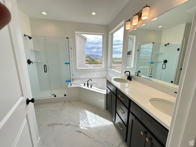 Full bath featuring a shower stall, a garden tub, double vanity, marble finish floors, and recessed lighting | Image 17