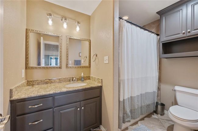 Bathroom with vanity and a shower with curtain | Image 8