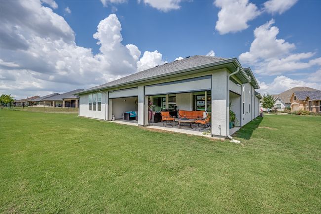 Rear view of property with screened patio area and a lawn | Image 22