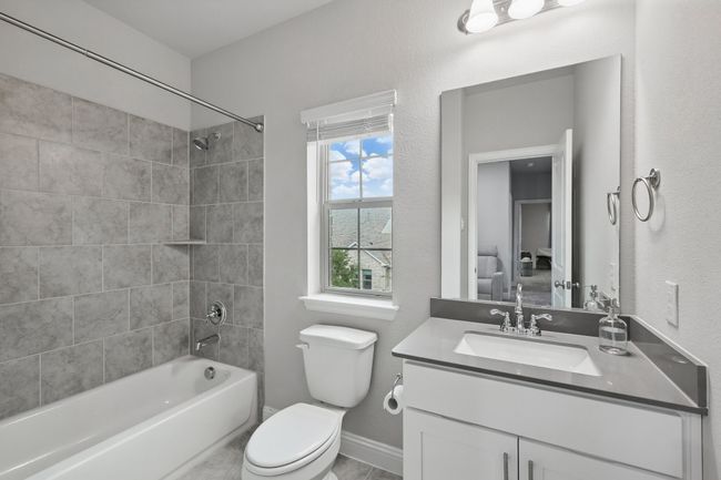 Bathroom featuring vanity, toilet, shower / washtub combination, and baseboards | Image 17