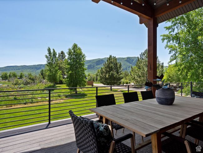 Deck with a mountain view and outdoor dining space | Image 50