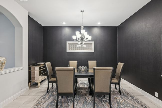 Dining space featuring a chandelier, arched walkways, baseboards, and recessed lighting | Image 11