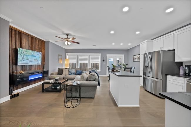 Living room featuring ceiling fan, ornamental molding, recessed lighting, baseboards, and light wood finished floors | Image 19