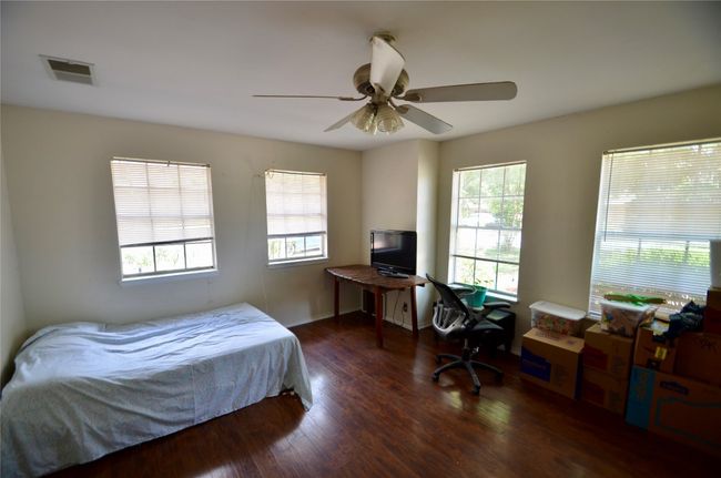 Bedroom featuring wood finished floors and a ceiling fan | Image 5
