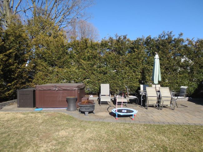 View of patio with an outdoor fire pit and a hot tub | Image 7