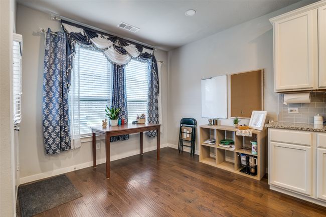 Home office with dark wood finished floors and baseboards | Image 13