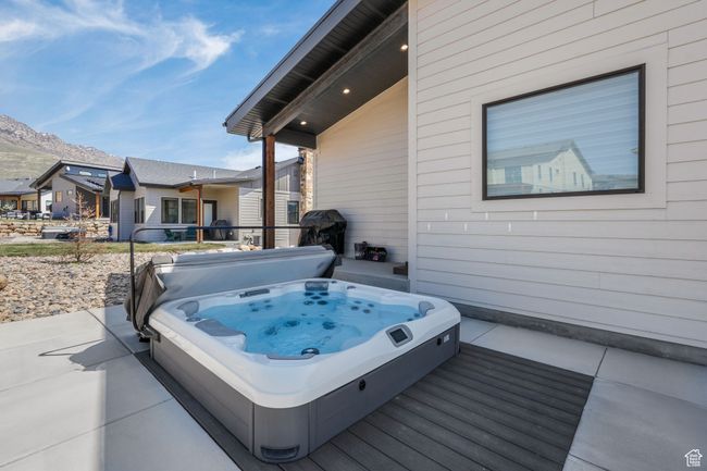 Nestled off the main level, a recessed hot tub offers an ideal escape for relaxation and rejuvenation, seamlessly integrating with the peaceful surroundings. | Image 48