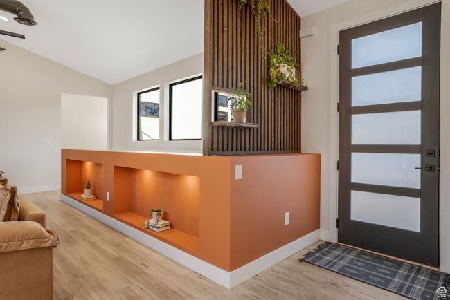 Entrance foyer with wood finished floors, baseboards, and lofted ceiling | Image 4