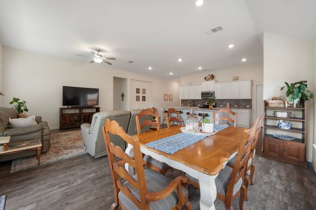 Dining space featuring wood finished floors, ceiling fan, and recessed lighting | Image 8