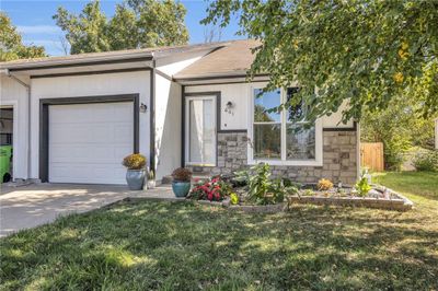 Ranch-style house featuring a garage and a front lawn | Image 3