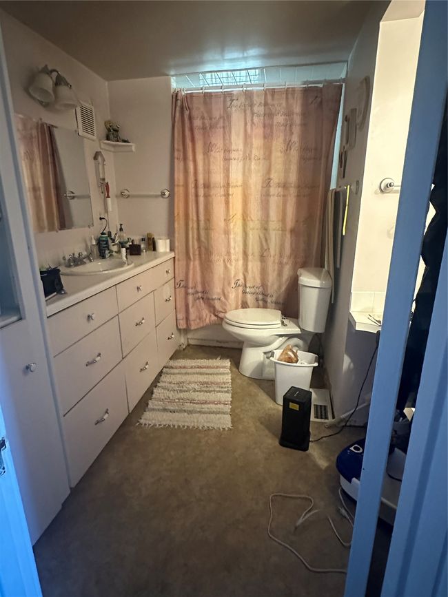 Bathroom with vanity, toilet, and a shower with shower curtain | Image 14