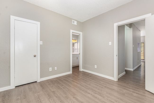 Unfurnished bedroom featuring light wood-style flooring, baseboards, and connected bathroom | Image 21
