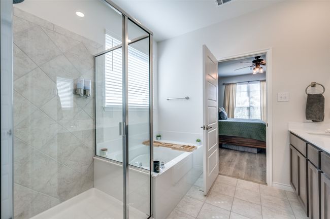 Ensuite bathroom with vanity, ensuite bathroom, a stall shower, and a garden tub | Image 11