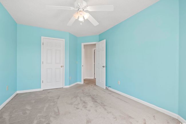 Unfurnished bedroom with carpet, baseboards, and ceiling fan | Image 24