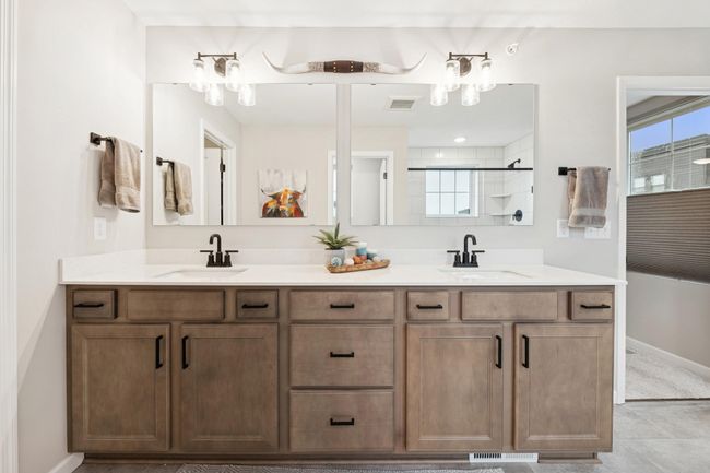 Sleek dual sinks with expansive mirrors, stylish lighting, and generous under-sink storage make this bathroom as functional as it is beautiful. | Image 30