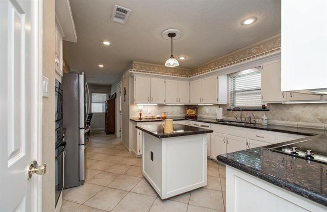No detail overlooked with under cabinet lighting, recessed lights and an outlet for the island. | Image 14