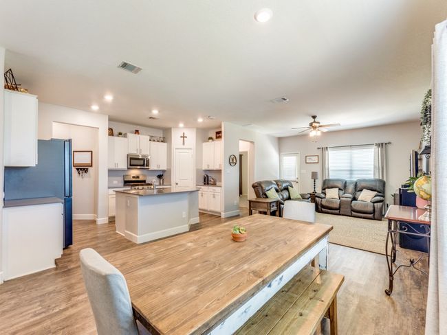 Dining area with light wood-style flooring, a ceiling fan, and recessed lighting | Image 10