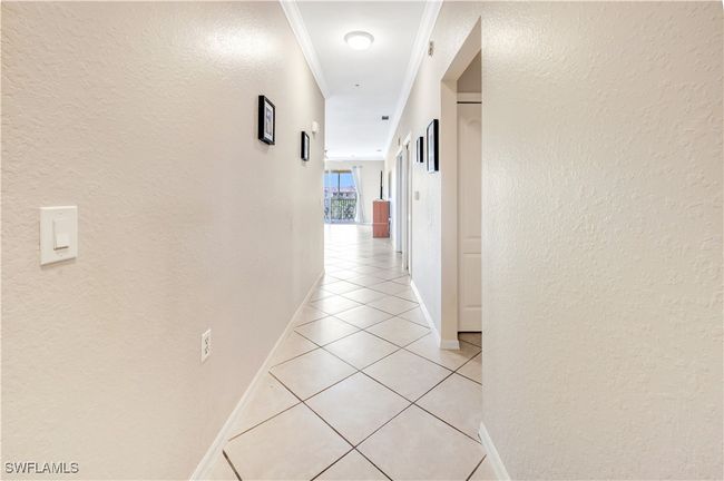 Foyer entrance with crown molding and light tile patterned floors | Image 4