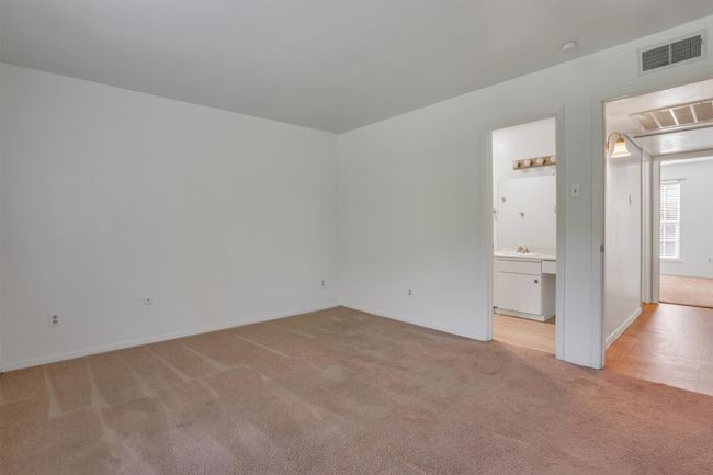 Bedroom with light colored carpet and baseboards | Image 17