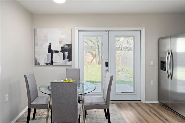 Dining area featuring baseboards and wood finished floors | Image 15