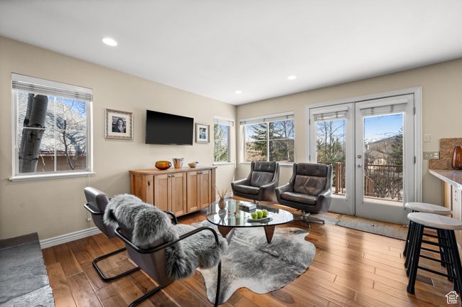 Living area with recessed lighting, a healthy amount of sunlight, hardwood / wood-style flooring, and french doors | Image 7