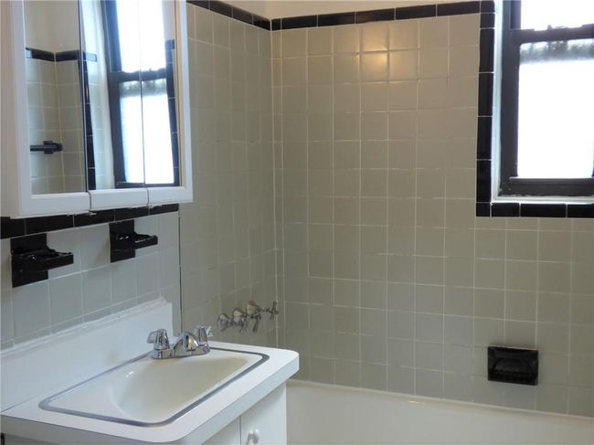 Bathroom with tile walls, shower / bath combination, and vanity | Image 14