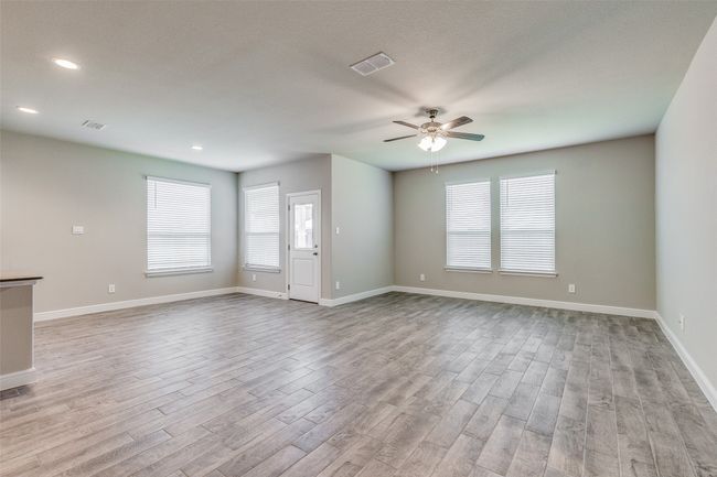 Spare room with ceiling fan, plenty of natural light, and light hardwood / wood-style floors | Image 4