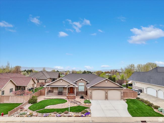 Traditional-style home with fence, a front lawn, concrete driveway, an attached garage, and covered porch | Image 4